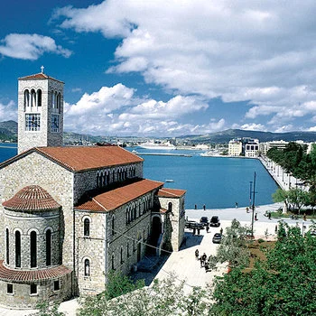 The imposing church of Saint Konstantinos, built in 1936, at the edge of the beach. The architect - Aristotelis Zachos - was inspired by the old christian churches of Thebes, that were discovered just a few years earlier at New Aghialos. The position of the temple, its design and its white temple and its exquisite mosaics make it unique.