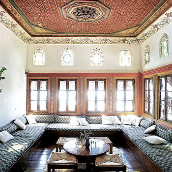 Vizitsa. The restored mansion, now a guesthouse, emerges imposing behind the wild flowers.